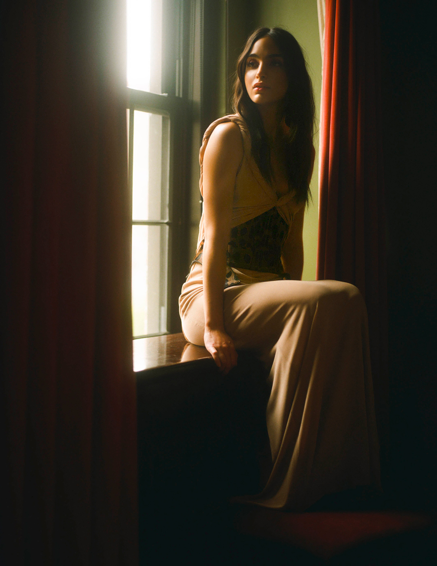 Attractive Sexy Blonde In Black Corset And Male White Shirt Posing  Provocatively. Portrait Of Sensual Woman Sitting On Wooden Cabinet Against  A Yellow Wall. Beautiful Fair Hair Fashionable Female Stock Photo, Picture