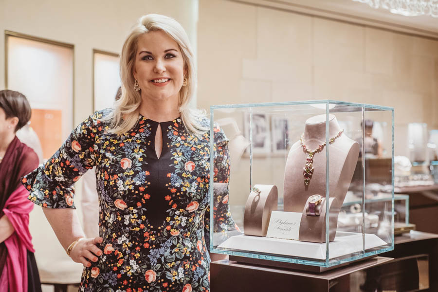 Stephanie Von Stein standing next to her jewelry selection for a charity event benefiting KNOWAutism hosted at the Bulgari Galleria Houston